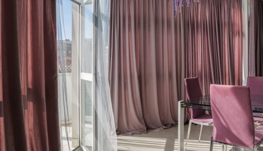 The sunlight through the fabric shade curtains on daytime. Summer and sunny day in a living room concept